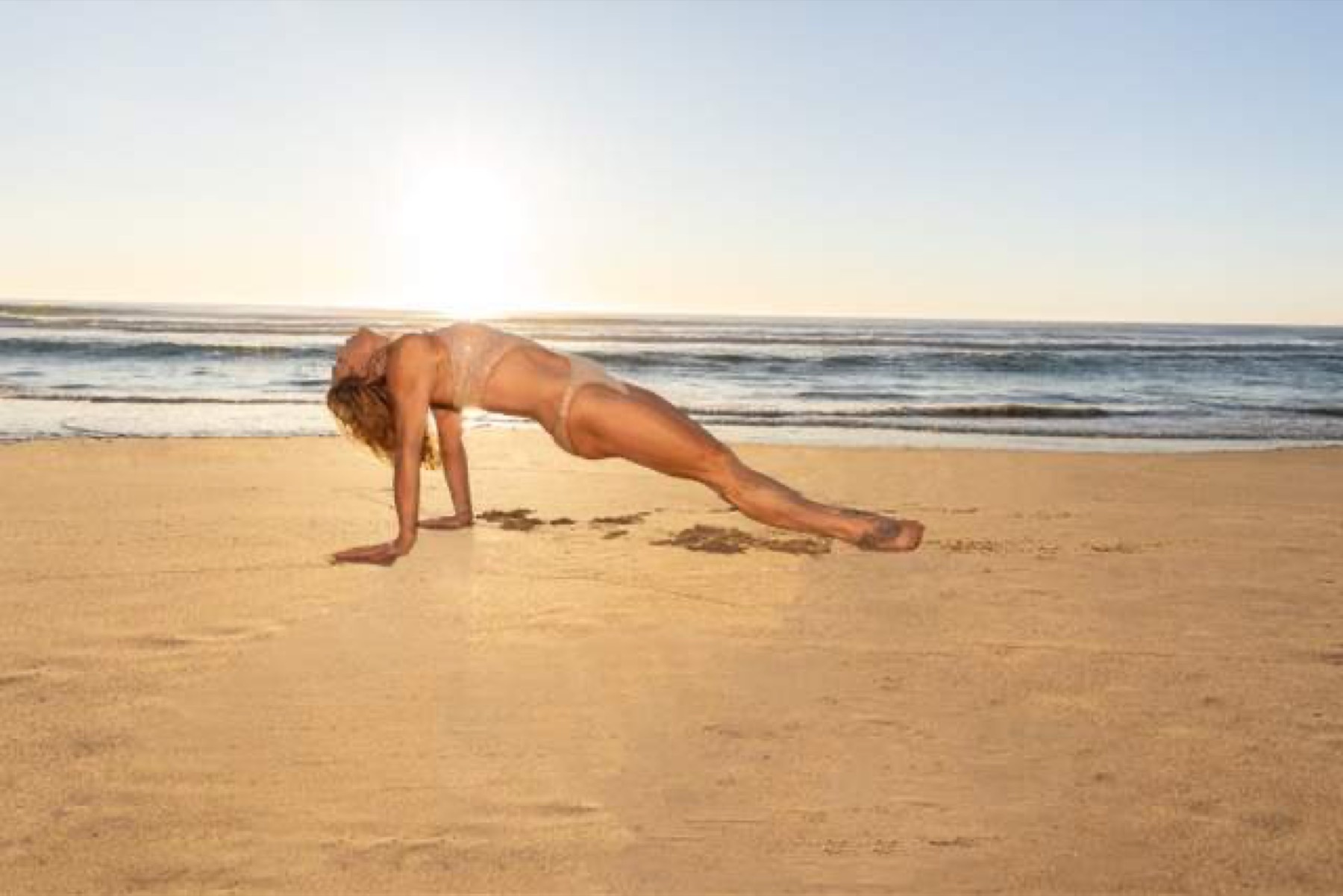Sunrise practice on the sand at the water&rsquo;s edge