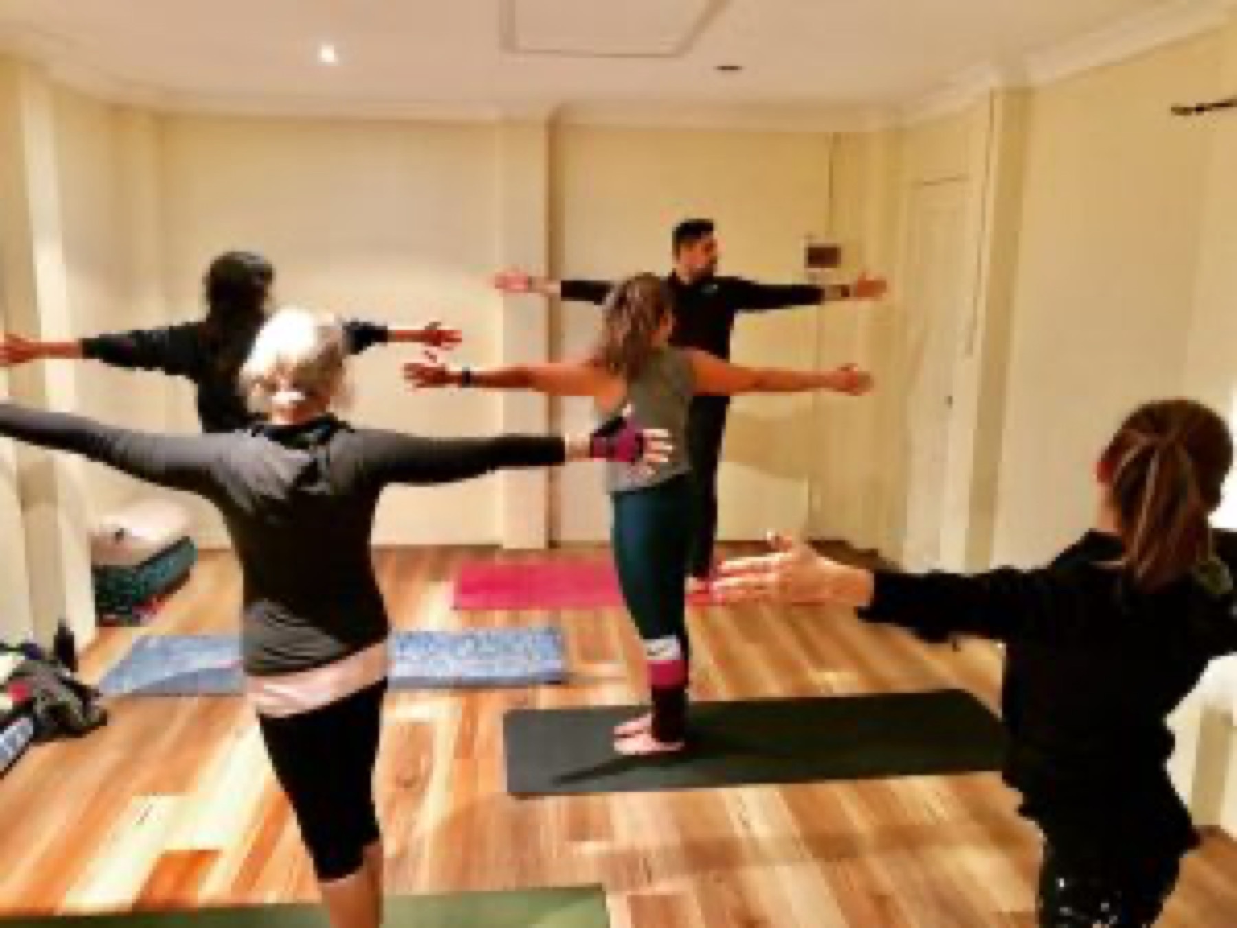 Students with arms wide during a standing sequence
